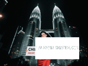 Woman in red dress holding sign: "Chinese & Malay | Escort | Callgirl | Incall & Outcall" in front of Petronas Towers.
